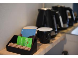 a counter with a coffee pot and a box on it at Hotel Discover Nagaokakyo - Vacation STAY 29771v in Nagaokakyo +1 photo