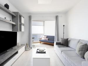 a living room with a couch and a tv at Live Candelaria Tamonante in Candelaria