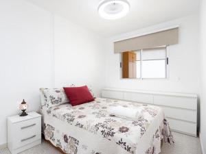 a white bedroom with a bed and a window at Live Candelaria Tamonante in Candelaria