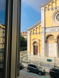 a yellow building with cars parked in front of it at Residenza Avogadro in Turin