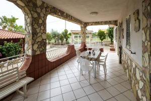 a patio with a table and chairs on a balcony at Villa Aurora in Altavilla Milicia