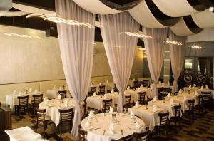 a dining room with white tables and chairs at Family Friendly Condo Steps to Miami Beach with Free Parking in Miami Beach