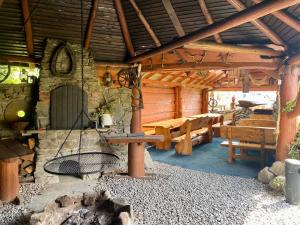 a wooden cabin with a table and benches in it at Rancho-Bierna in Bierna