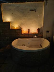 a large bath tub in a room with lights at Casa Rural Villa montecarmelo in Sanlúcar la Mayor