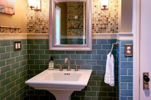a bathroom with a sink and a mirror at Half-Mi to Riverwalk Midtown Reno Oasis! in Reno +14 photos