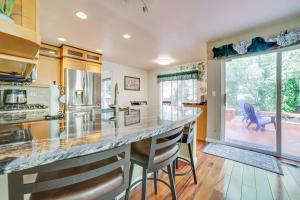 a kitchen with a large counter and a large window at 1 Mi to Downtown Reno Spacious Home with Deck! in Reno