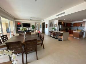 a dining room and living room with a table and chairs at Puerto Vallarta Del Canto Luxury in Bucerías