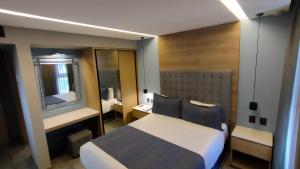 Una cama o camas en una habitación de Alia Inn Boutique WTC