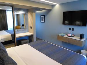 Una cama o camas en una habitación de Alia Inn Boutique WTC