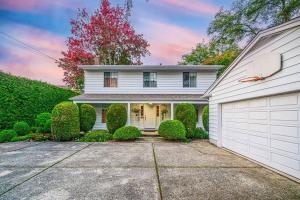 a white house with a garage at Garden Hotel 3-bedroom house for whole book in Richmond