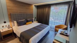Una cama o camas en una habitación de Alia Inn Boutique WTC