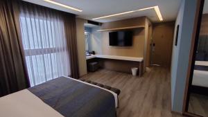 Una cama o camas en una habitación de Alia Inn Boutique WTC