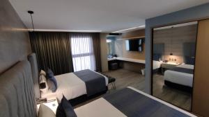 Una cama o camas en una habitación de Alia Inn Boutique WTC