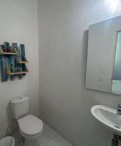 a white bathroom with a toilet and a sink at Zana Hotel Boutique in Bogotá