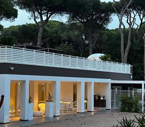 a house with white columns and a roof at VillaLume in Marina di Castagneto Carducci