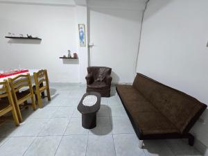 a room with a couch and a chair and a table at Céntrico departamento en el Piso 1 in Tacna