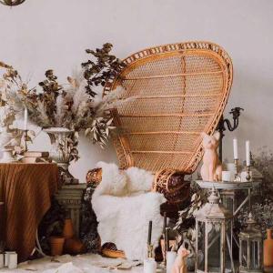 a large wicker chair sitting next to a table at CHENGDU Liaofan Design B&B Houwu Temple Jinli Twin Suite Ximenqiao Street Morogo White Castle HD Projection LOFT Double Floor Bnb High-Quality Housing in Chengdu