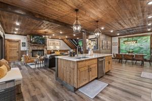 a kitchen and living room with wooden ceilings and a dining room at Teresa's River Retreat in Blue Ridge