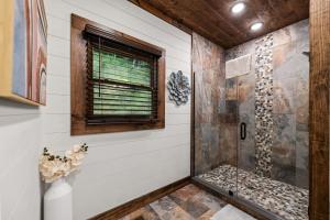 a bathroom with a shower and a window at Teresa's River Retreat in Blue Ridge +42 photos