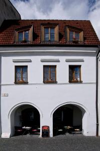 a white building with arches in front of it at Apartments Rakoczi in Žilina