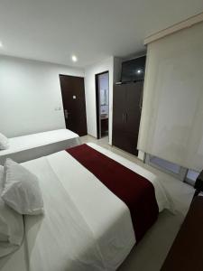 a large bedroom with a large white bed in it at Hotel Ipanema Meridian in Neiva