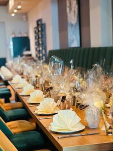 a long table with napkins and glasses on it at Hotel im Brühler Hof in Brühl