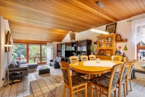 a kitchen and living room with a wooden ceiling at Familyhouse Cologne in Hürth