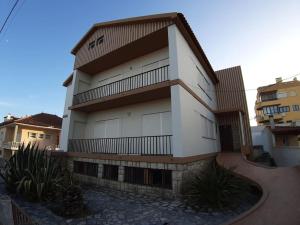 a white building with balconies on the side of it at Casa dos Peixes, um refúgio à beira mar in Vieira de Leiria