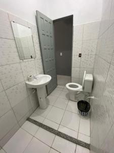 a bathroom with a toilet and a sink at Pousada Mutary in Santa Cruz Cabrália