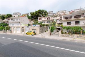 a yellow car parked on the side of a street at Apartment Zvone in Sumpetar +9 photos