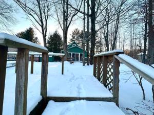 a wooden fence covered in snow with a gazebo at Lakefront with Lots of Light and Private Dock Access in Ferndale