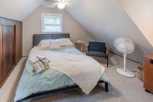 a bedroom with a bed and a chair at Lakefront with Lots of Light and Private Dock Access in Ferndale