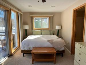 a bedroom with a large bed and a window at Lakefront with Lots of Light and Private Dock Access in Ferndale