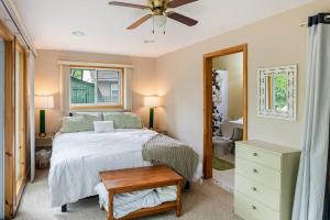 a bedroom with a bed and a ceiling fan at Lakefront with Lots of Light and Private Dock Access in Ferndale
