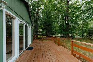 a wooden deck on the side of a house at Lakefront with Lots of Light and Private Dock Access in Ferndale