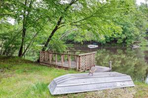 a wooden bridge over a river with a bird sitting on it at Lakefront with Lots of Light and Private Dock Access in Ferndale