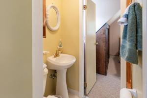 a bathroom with a sink and a toilet and a mirror at Lakefront with Lots of Light and Private Dock Access in Ferndale +37 photos