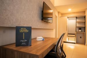 a table with a book sitting on top of it at Grand Hotel&Casino Vía Dorada in Pachuca de Soto +46 photos