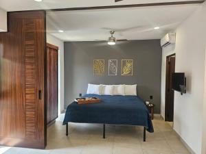 a bedroom with a bed with a blue blanket at Estudio de ensueño con alberca 303 in Puerto Vallarta +76 photos