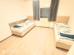 a small room with two beds and a window at FMI 66 Next to Airport in Mörfelden-Walldorf