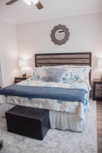 a bedroom with a bed and a mirror on the wall at Beachside Bungalow in Navarre