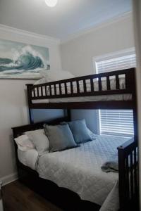 a bedroom with two bunk beds in a room at Beachside Bungalow in Navarre
