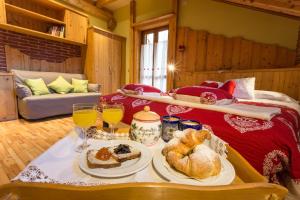 a table with bread and pastries on it in a room at Hotel La Baita in Malborghetto Valbruna