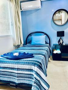 a blue bedroom with a bed with a blue wall at Apartment Coral near Mamitas Beach in Playa del Carmen