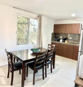a kitchen with a dining room table and chairs at Apartment Coral near Mamitas Beach in Playa del Carmen