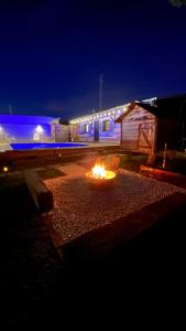 a fire pit in front of a building at night at La Casita in Cuartillos
