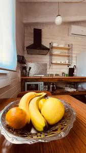 a plate of bananas and oranges on a table at La Casita in Cuartillos
