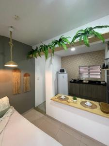 a kitchen with a counter with a refrigerator at Residencial Temporada Aracaju in Aracaju
