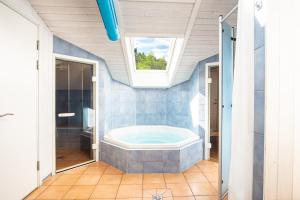 a bathroom with a jacuzzi tub and a window at Strandblick - Dorf 1 Ferienhaus 07 in Priwall +65 photos