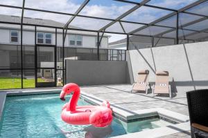 una piscina con cigno rosa in acqua di Family Friendly 5Bd Close to Disney at Windsor Cay 1269 a Orlando